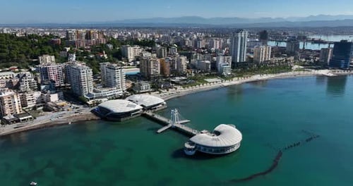 Aerial Orbit Tilt Down of Durres Pier and Coastal Urban Scene in Albania