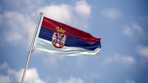 Realistic Waving Flag of Serbia Against Blue Sky