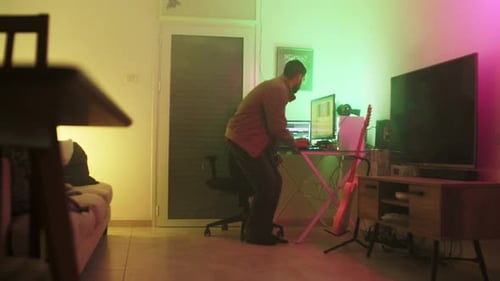 Man Works on Computer in Colorful Room