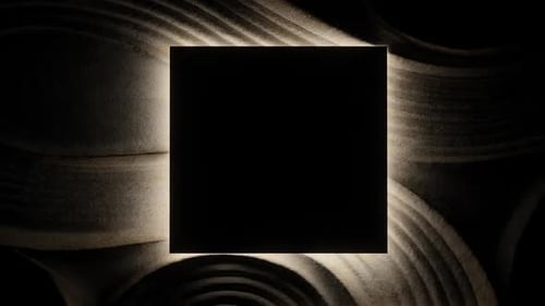 Square light revealing textured sand surface.