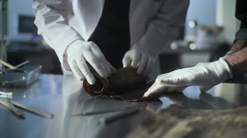 Scientists Unrolling Ancient Scroll in Laboratory