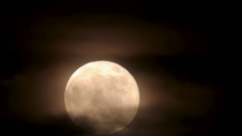Full Moon Shining Through Night Clouds