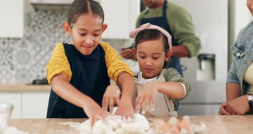 Girls Knead Dough with Parents in Kitchen