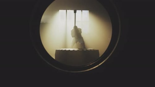 Muscular Man Swings Sledgehammer on Tire in Gym