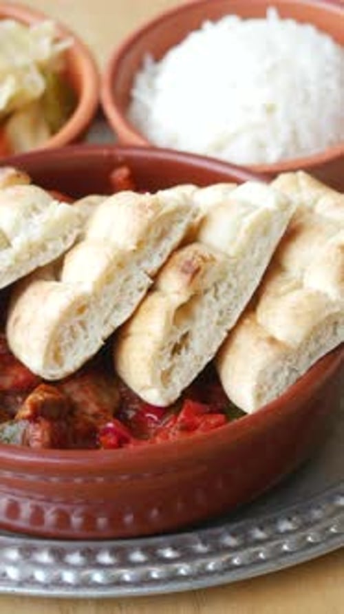 Delicious Meat Dish with Flatbread, Rice, and Pickles
