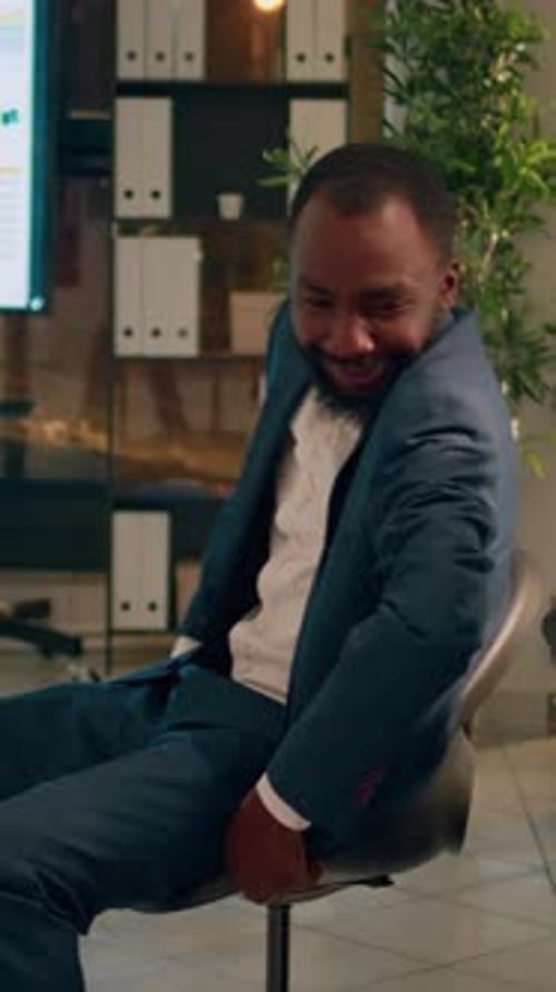 Cheerful Man Celebrates Success in Office Setting