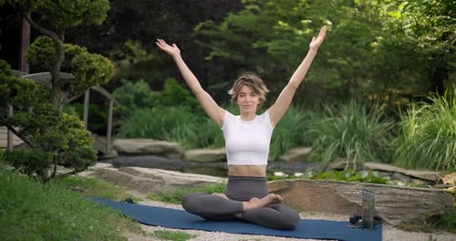 Woman Practicing Yoga Outdoors in Peaceful Setting