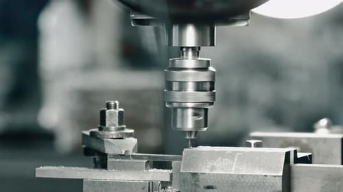 Metal piece precision cnc milling and drilling in industrial workshop