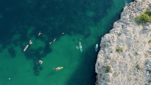 Aerial view of people swimming kayaking and paddleboarding in the Croatia Mediterranean Adriatic