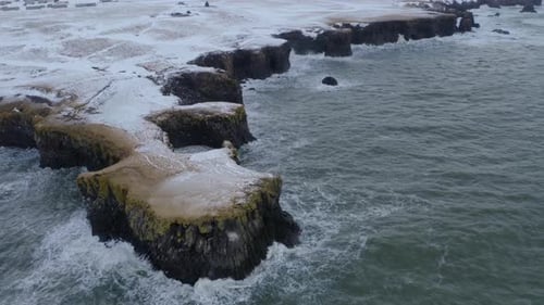 Ocean Waves Hitting The Rocky Cliff And Coastline Of Arnarstapi In Iceland. - aerial