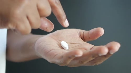 Young Men Taking Medical Pill