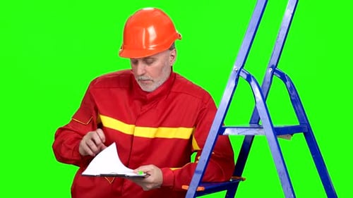 Mature Caucasian Contruction Worker in Red Uniform