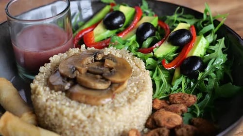 Quinoa Bowl with Mushrooms, Salad, and Spring Rolls