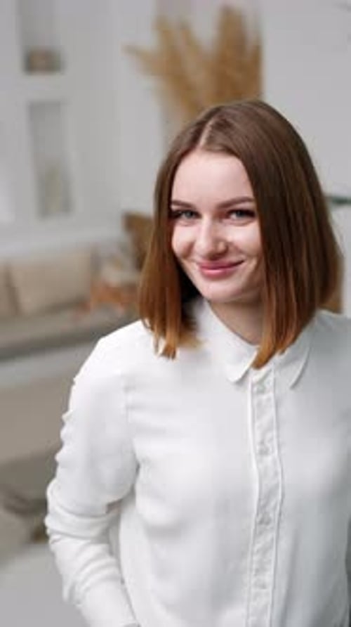 Smiling Young Woman Poses in Home Interior