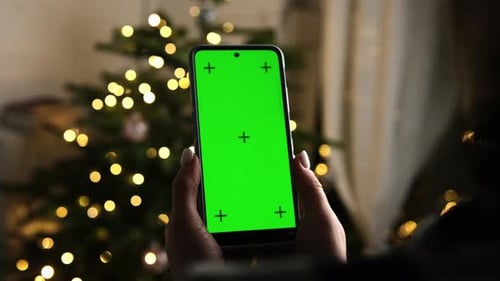 Girl Holding In Hands A Smartphone With Chroma Key Green Screen With Marks