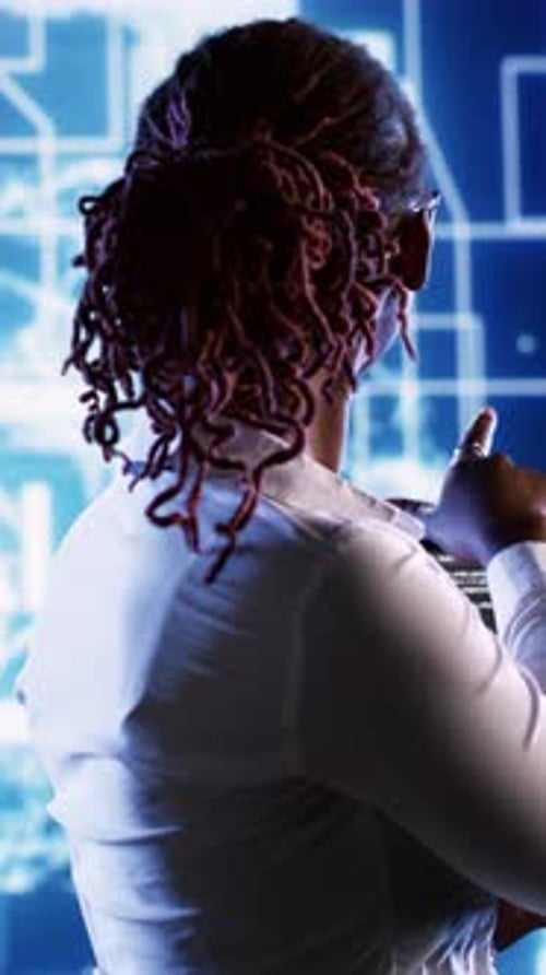Woman Analyzing Data on Futuristic Digital Display