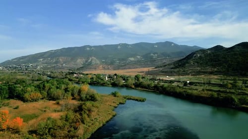 Aerial Close Pan over kura river in Mtskheta