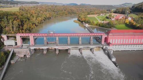 Aerial view of large river dam with flowing water