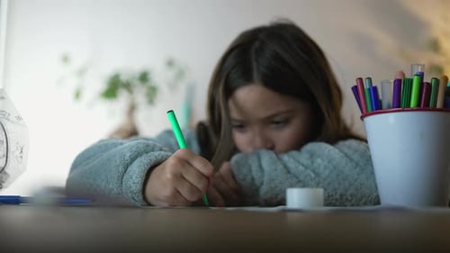 Girl Drawing with a Marker Indoors