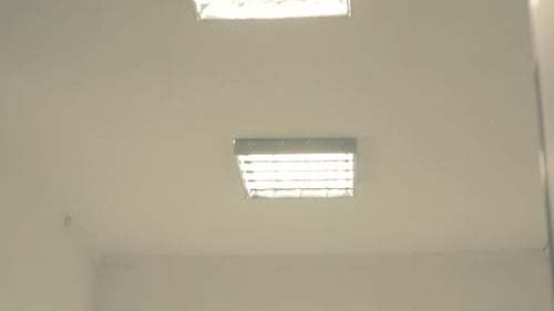 Hospital Interior - Ceiling Lights At The Empty Corridor - low angle, tilt down