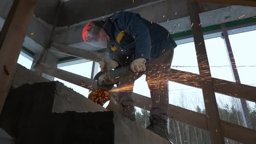 Worker Welding Metal Pipe with Many Sparks are Flying in Different Directions in the Dark Clip