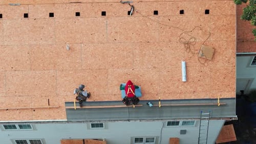 Roofers Installing a New Roof on an Residential Building Aerial Top Down Footage