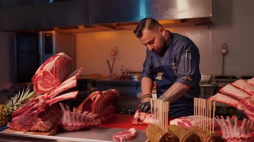 Chef Cuts Raw Meat in Professional Kitchen