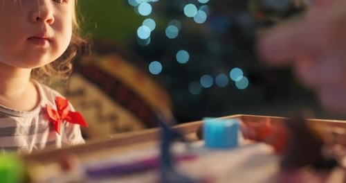 Kid and plasticine toys. Toddler girl plays with self made plasticine toys at home