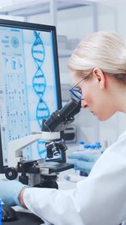 Woman Scientist Works with Microscope in Laboratory