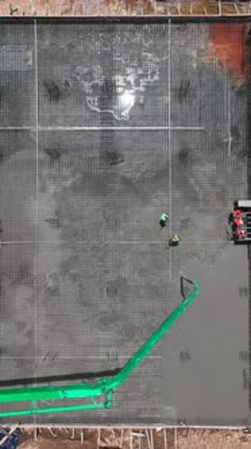 Vertical Video Dynamic Construction Timelapse with Builders and Machines Operating Rapidly on a Busy