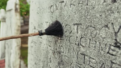 Cleaning Stone Tablet With Ancient Inscriptions