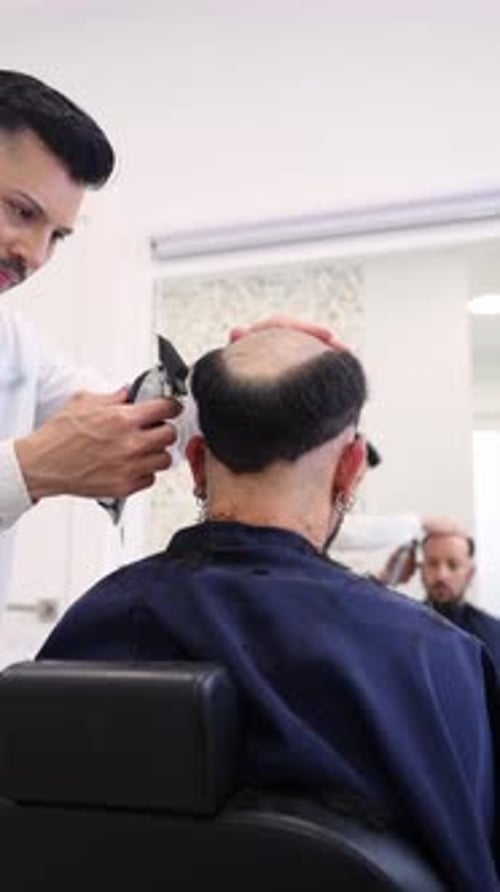 Barber Trims Hair in Bright Salon