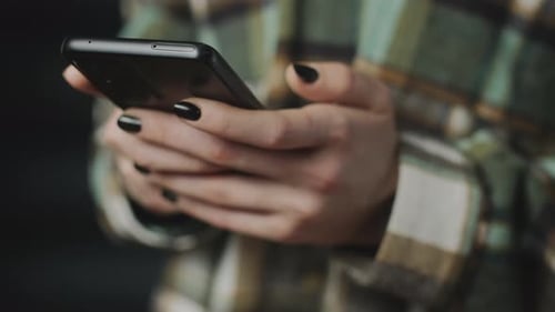 Woman Holding Cellphone in Hand Close Up