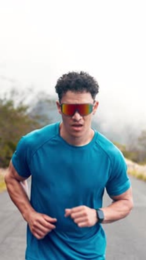 Cardio, athlete and man with sunglasses, outdoor and running for wellness on road