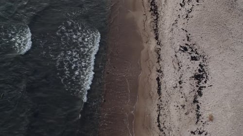 Aerial view of drones flying over waves on the sand beach view from above