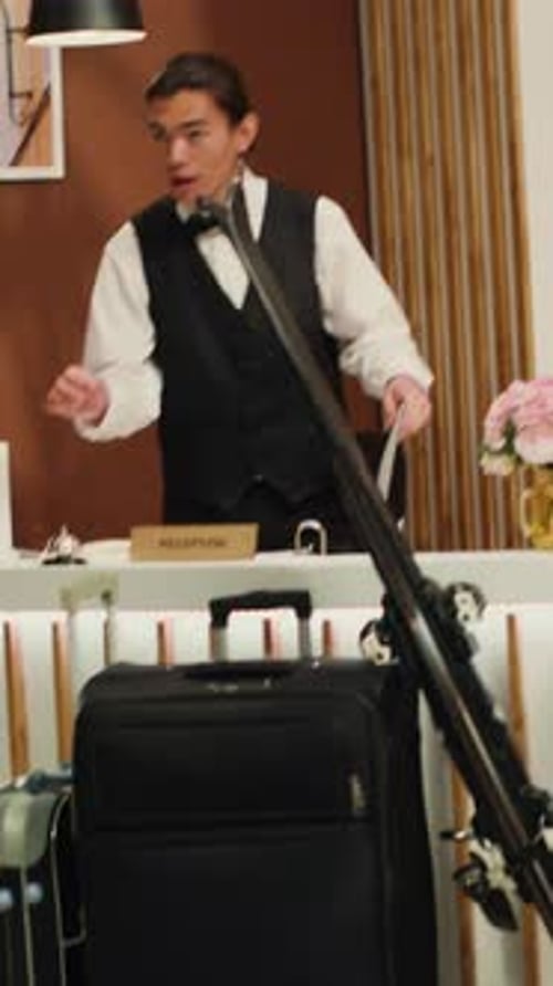 Hotel Employees at Reception Desk Assisting Customers