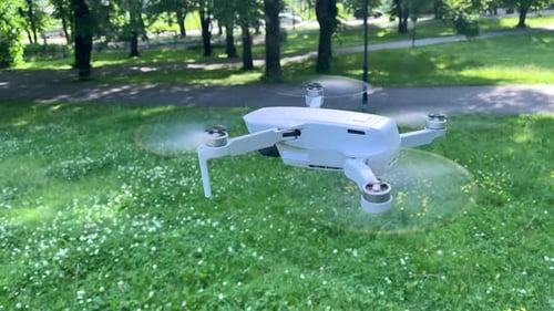 Amazing Side Closeup View Shot of Drone Hovering in Windy Green Park