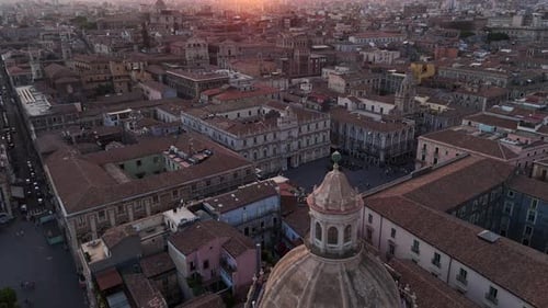 An old european city at sunset with red-tiled roofs and historic buildings, aerial view
