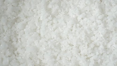 Flower of salt, a premium sea salt, forms delicate crystals on salt ponds' surfaces.