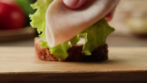 Close Up Food Preparation with Bread, Ham and Lettuce