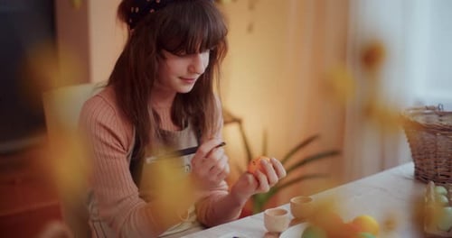 Young Girl Painting Easter Eggs for Easter Holidays