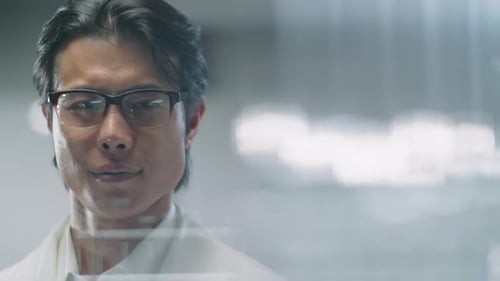 Portrait of Confident Asian Scientist behind Glass Wall in Lab