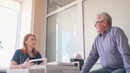 Doctor Consults with Patient in Medical Office