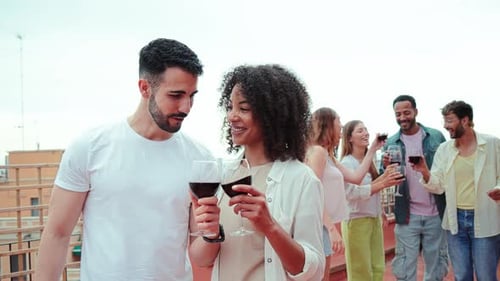 Friends Celebrate with Wine on Rooftop