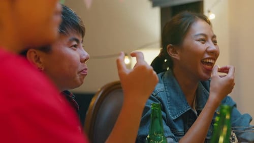 Friends Celebrating Together at Cheerful Indoor Party