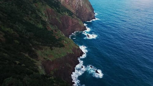 Dramatic Sea Scene with Towering Rocks Meeting Turbulent Ocean Waves