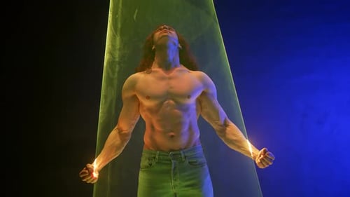 Sporty Handsome Muscular Man Portrait Under Colorful Illumination Laser Light