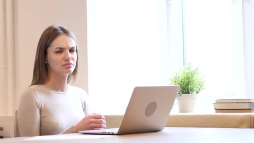 Woman Works at Laptop by Bright Window