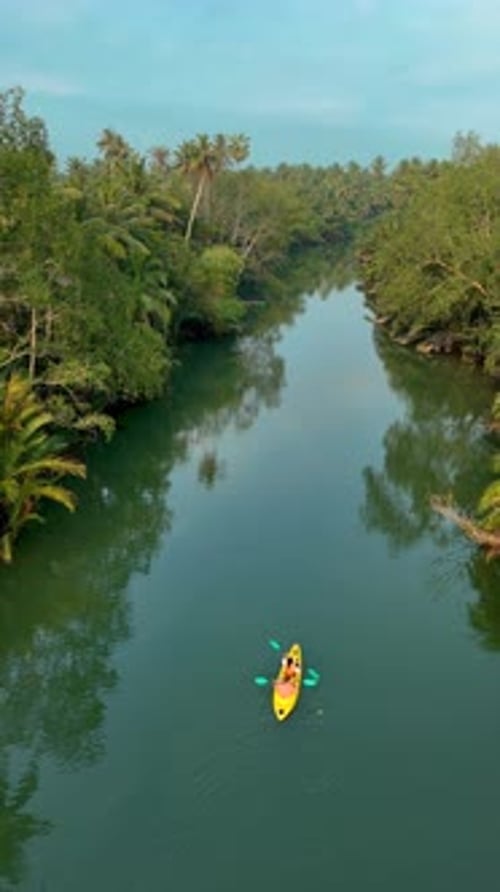 Paddling Through the Serene Waterways of Chumphon Thailand Surrounded By Lush Greenery