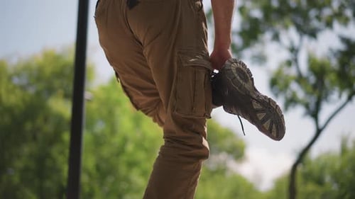 Man Stretching Limbs Outdoors Before a Run